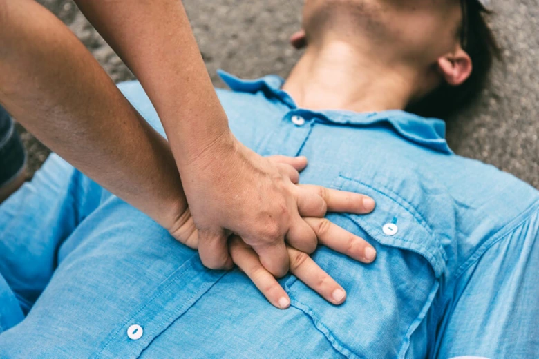 Praktický ukázka provádění kompresí hrudníku při resuscitaci.