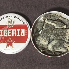 Otevřená krabička šňupacího tabáku značky Iberia s obsahem.