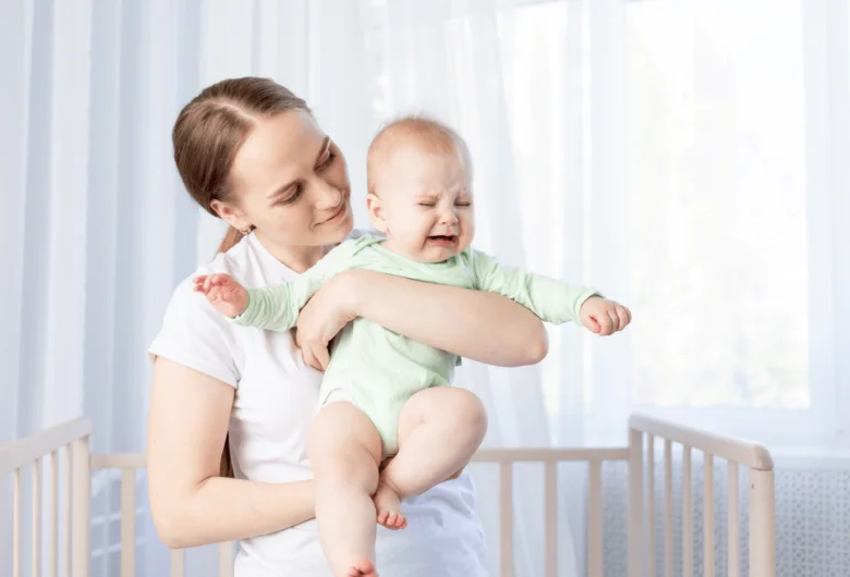 Mother holding crying baby