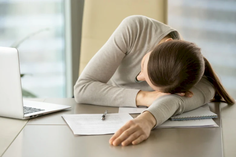 Woman sleeping at desk