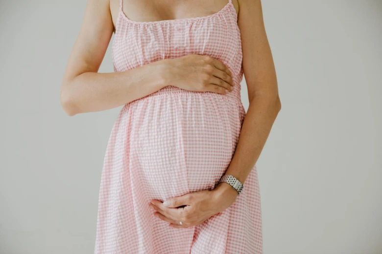Pregnant woman holding belly