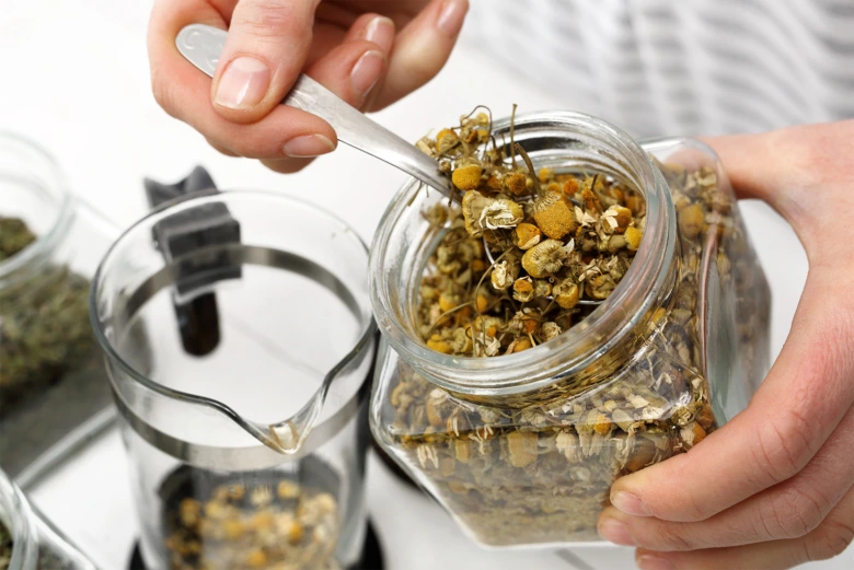 Dried chamomile flowers in jar