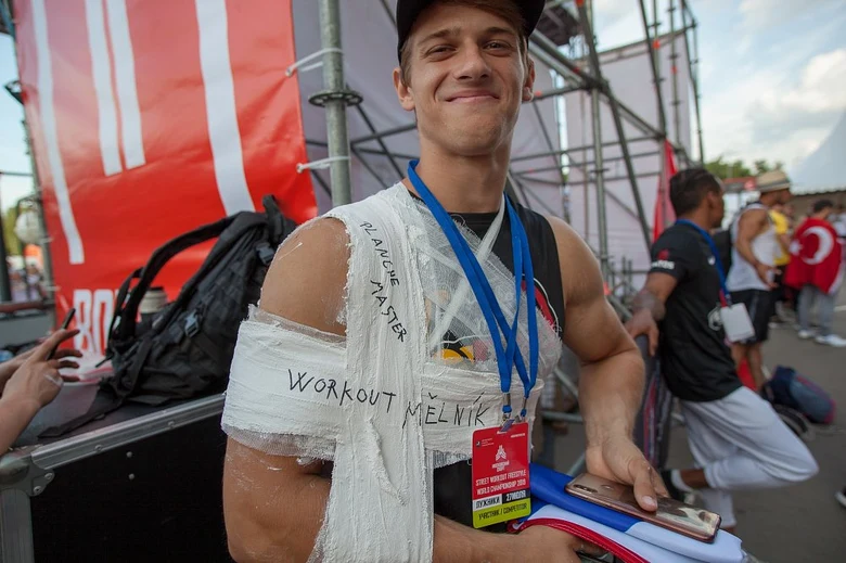 Muž s obvazem na paži po zranění během sportovní události.