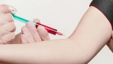 Odběr krve z paže pacienta do stříkačky.