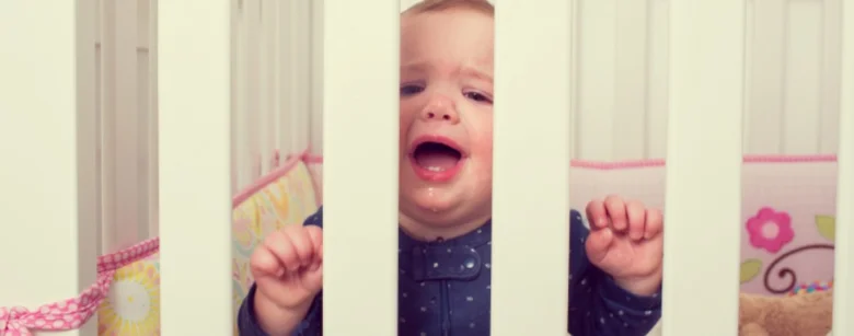 Crying baby in crib