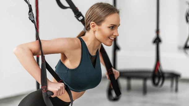 Woman exercising with straps