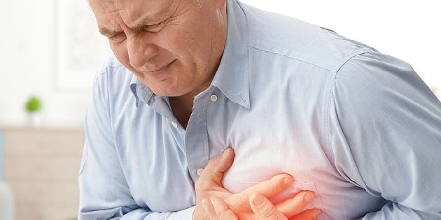 Man clutching chest in pain