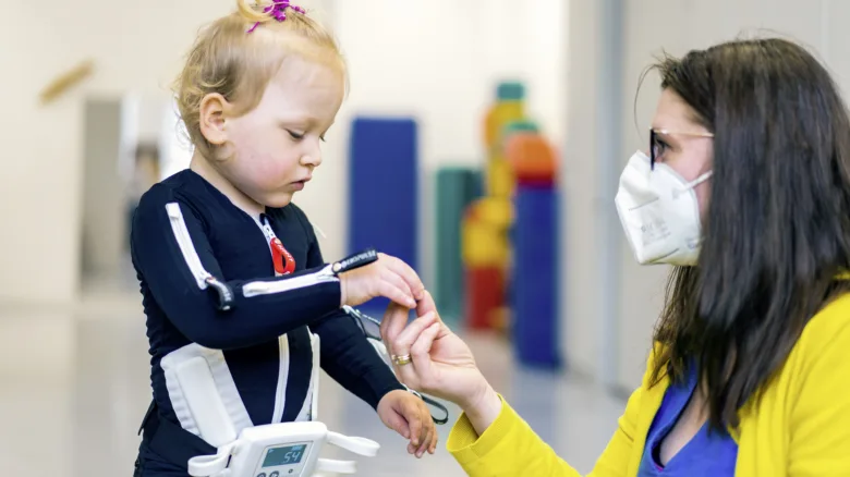 Child with cerebral palsy and therapist
