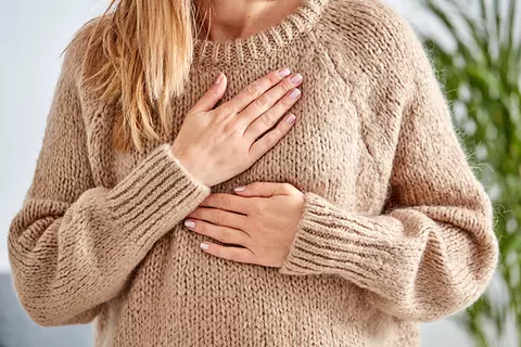 Pregnant woman hands on chest